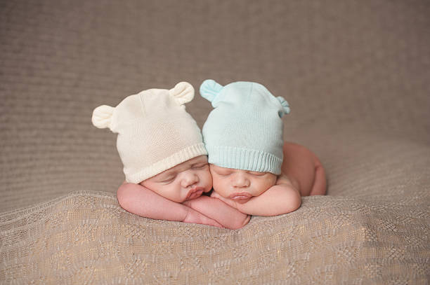 istock Newborn Twins Sleeping in Knit Hats 174286433