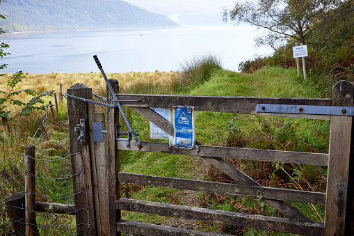 A wooden farm gate on path by Loch Goil at Carrick Castle