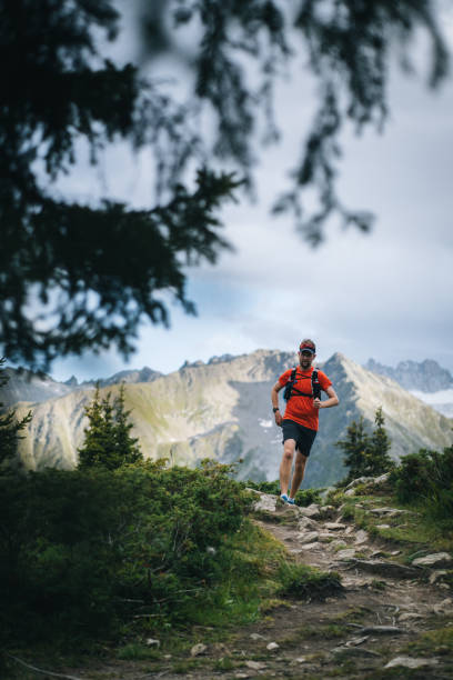 istock Trail runner bounds along mountain trail 1742876429