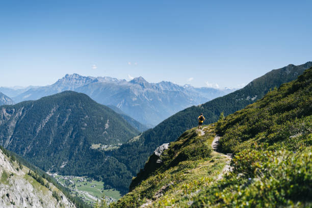 istock Trail runner bounds along mountain trail 1742880172