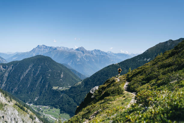 istock Trail runner bounds along mountain trail 1742880686