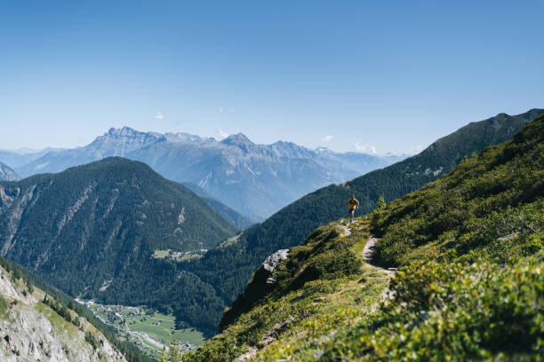 istock Trail runner bounds along mountain trail 1742881232