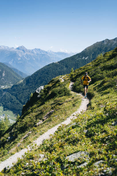 istock Trail runner bounds along mountain trail 1742881798