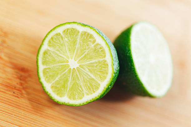 istock Cut lime on a wooden board 174290405