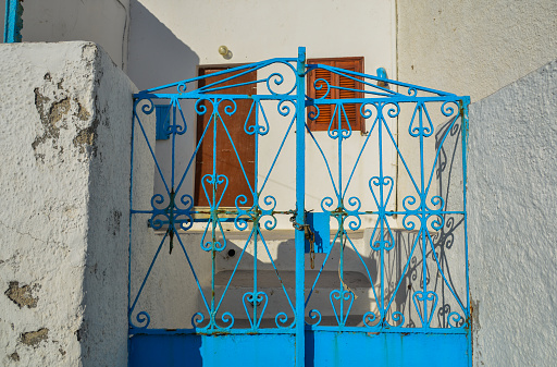 Old blue iron gate of a typical house on Santorini Island, Greece.