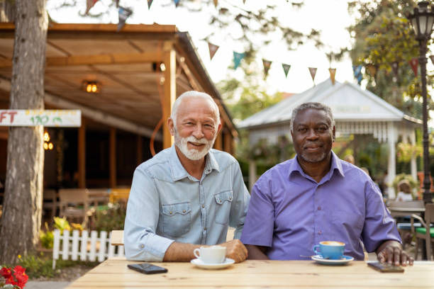 istock Senior Friends Looking at Camera at Coffee Shop 1742913399