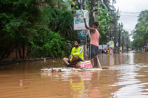 People travel on a raft on a waterlogged road after heavy rainfall, on October 6, 2023 in Guwahati, Assam, India. Severe water logging witnessed in Guwahati city following heavy rains, as the India Meteorological Department (IMD) predicted.