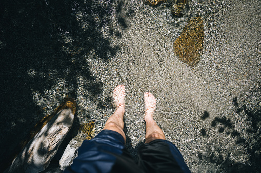 Man with sneakers and barefoot girl are enjoying their holiday evening