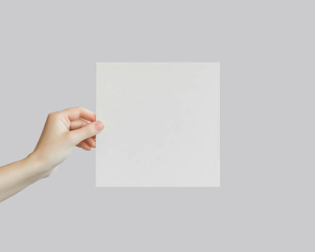 istock female hand holds an empty white banner. mockup, space for the text 1742934523