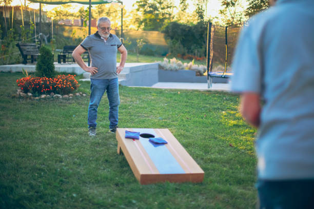 istock Two old friend play corn hole in backyard 1742953548