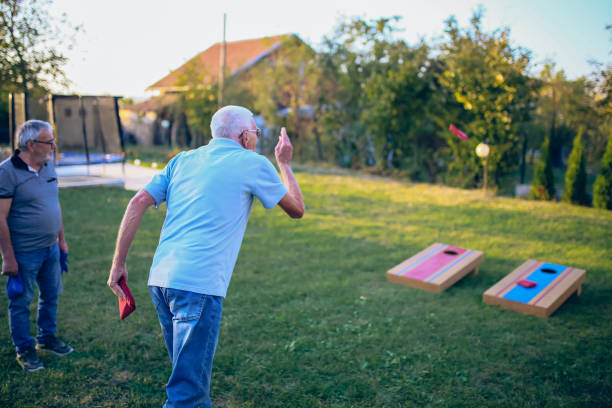 istock Two old friend play corn hole in backyard 1742954169