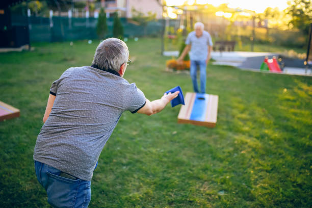 istock Two old friend play corn hole in backyard 1742954730