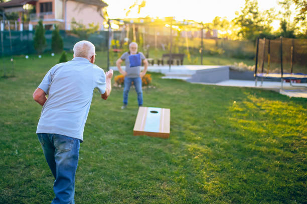 istock Two old friend play corn hole in backyard 1742955290