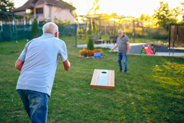 istock Two old friend play corn hole in backyard 1742955534