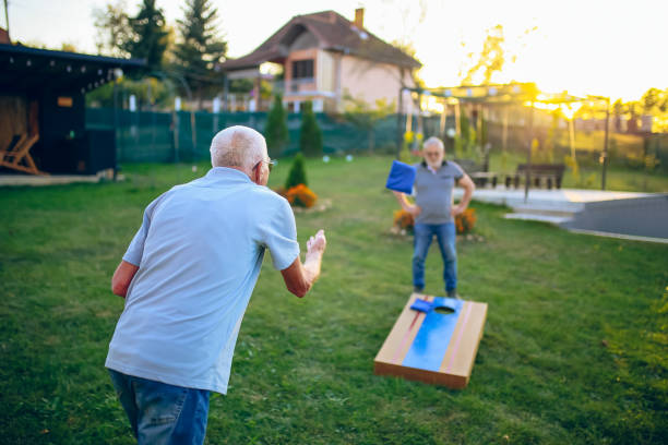 istock Two old friend play corn hole in backyard 1742955884