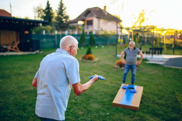istock Two old friend play corn hole in backyard 1742956418