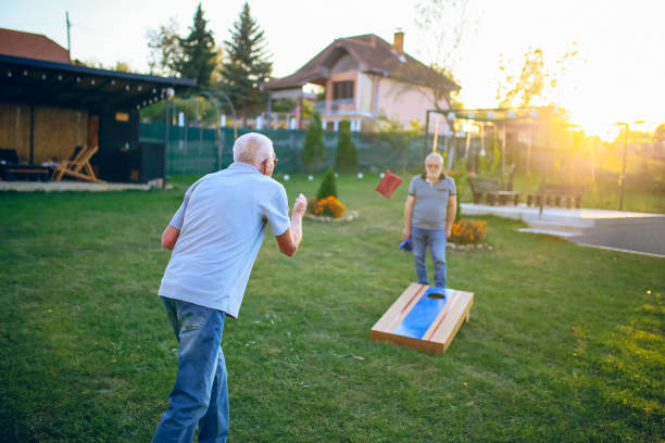 istock Two old friend play corn hole in backyard 1742956463