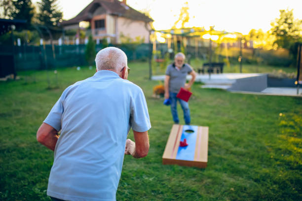 istock Two old friend play corn hole in backyard 1742956994