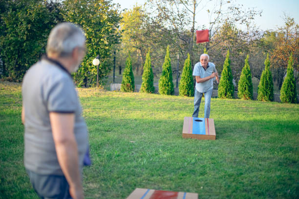 istock Two old friend play corn hole in backyard 1742957590