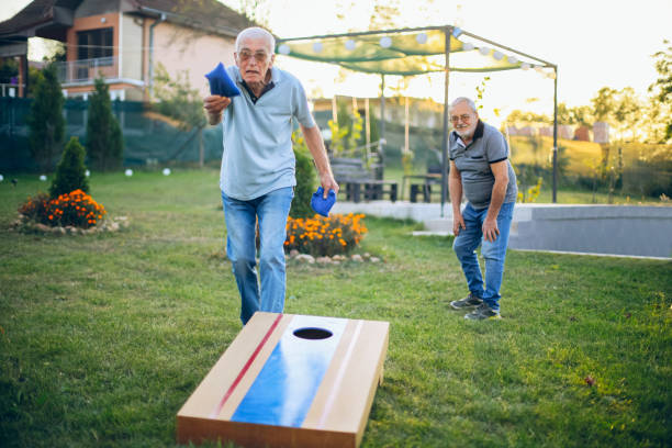 istock Two old friend play corn hole in backyard 1742958170