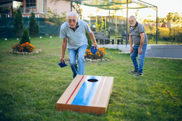 istock Two old friend play corn hole in backyard 1742958214