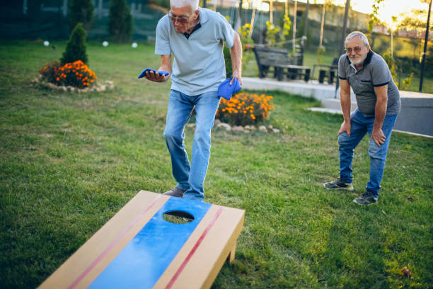 istock Two old friend play corn hole in backyard 1742958781