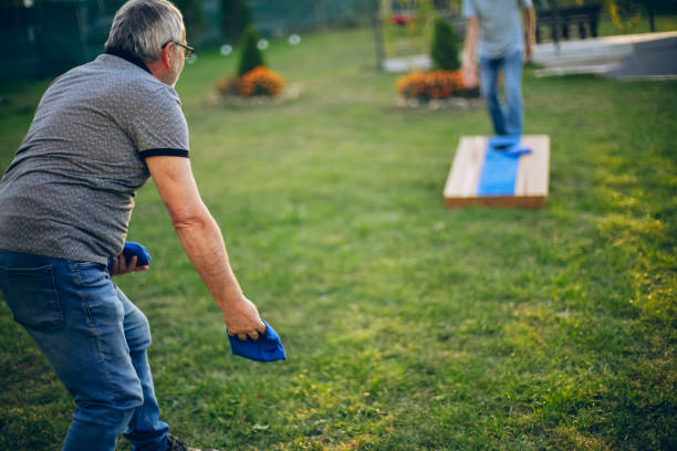 istock Two old friend play corn hole in backyard 1742959356
