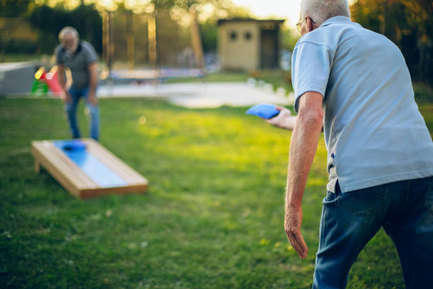 istock Two old friend play corn hole in backyard 1742960138