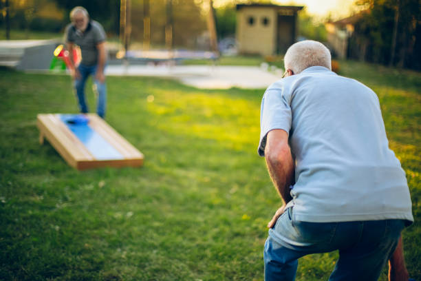 istock Two old friend play corn hole in backyard 1742960473