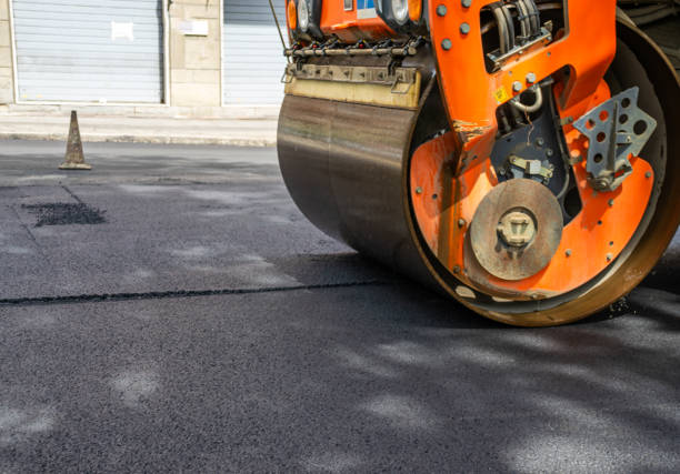 istock Orange Tractor with cylinder for asphalt paving on road 1742979817