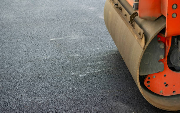 istock Orange Tractor with cylinder for asphalt paving on road 1743020362