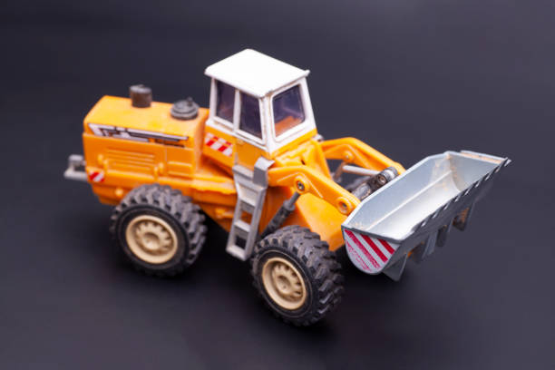 istock Toy tractor with bucket, on a black background 1743025686