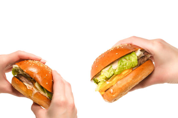 istock Hamburger in woman hands isolated on a white background. 1743031072