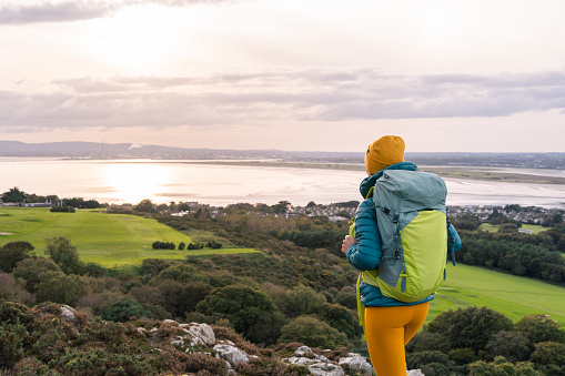 Traveler woman with her backpack admiring the landscape of Dublin Bay, Ireland