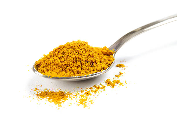 Spices in the spoon on the isolated background
