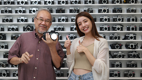 The elder man and his daughter presenting Camera products in their own store