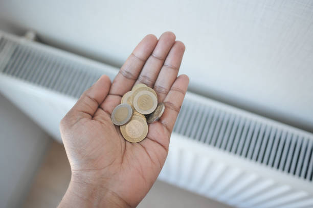 istock coins on hand against Radiator To Save On Energy Bill 1743072707