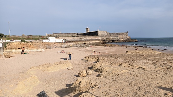 12.04.2023 Rocky beach, oceanfront and beachfront fortress in Carcavelos, Lisbon, Portugal photo