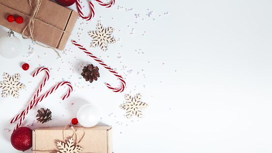 Christmas background with decorations, gift boxes on a white table. Christmas background. Flat lay. top view with copy space