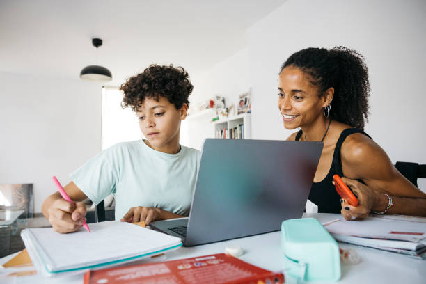 Girl doing her homework with mother
