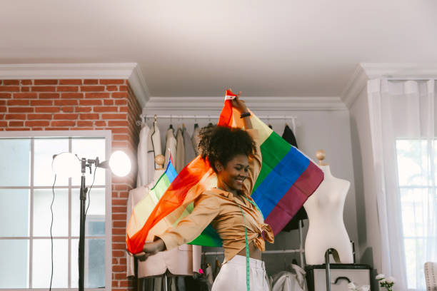 happy women standing with a pride rainbow flag. - homosexual gay pride business rainbow imagens e fotografias de stock