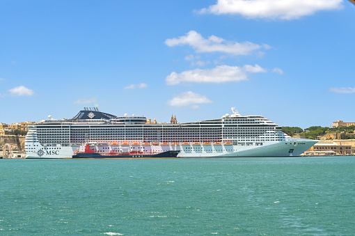 Yokohama, Japan - August 15, 2018: It is a Ōsanbashi Pier of Yokohama Port. A big luxury liner is anchored.The name of the ship is ’Diamond Princess’. She sails under British colours. There are lots of lifeboats lining up.