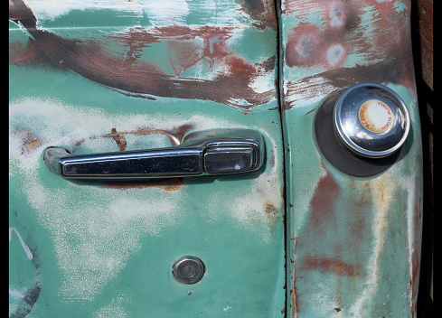 Close up of an old trucks door handle.
