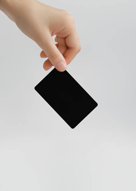 istock woman holding blank black plastic card on gray background 1743121938