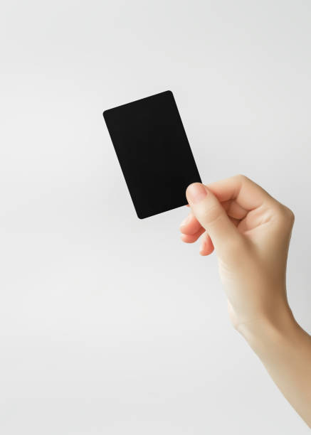 istock woman holding blank black plastic card on gray background 1743121960