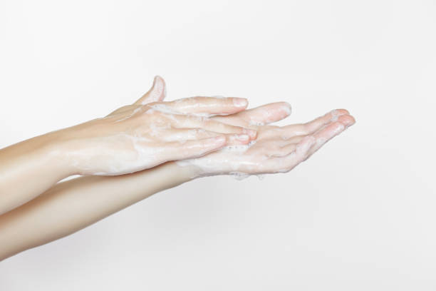 istock woman washes hands with soap on a white background 1743122000