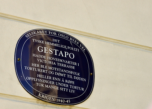 Oslo, Norway: Gestapo plaque at Royal Norwegian Ministry of Foreign Affairs headquarters - Victoria terrasse building, completed in 1890 - During the occupation of Norway in April 1940, the building was taken over by the German police authorities Sicherheitsdienst (SD) and Sicherheitspolizei (SiPo) which included the Secret State Police (Gestapo) and the Criminal Police (Kripo). It was intended as a headquarters for the leadership of SiPo and Sicherheitsdienst (SD), where Heinrich Fehlis was commander (BdSuSD), but in February 1945 he moved his headquarters to Furulund in west Oslo, while SiPo's commander remained at Victoria Terrace. Here was the interrogation room for all the prisoners in Oslo, and the name \