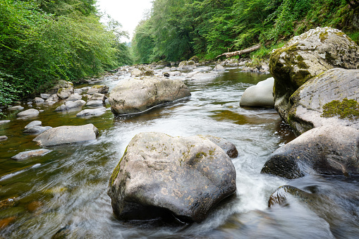 Motion blur of water flowing over rocks in a river