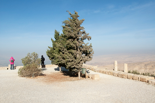 Amman, Jordan. December 30, 2005. Two tourists filmed from behind admire the desert landscape near the Jordanian capital