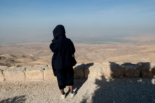 Amman, Jordan. December 30, 2005. A tourist shot from behind admires the desert panorama near the Jordanian capital